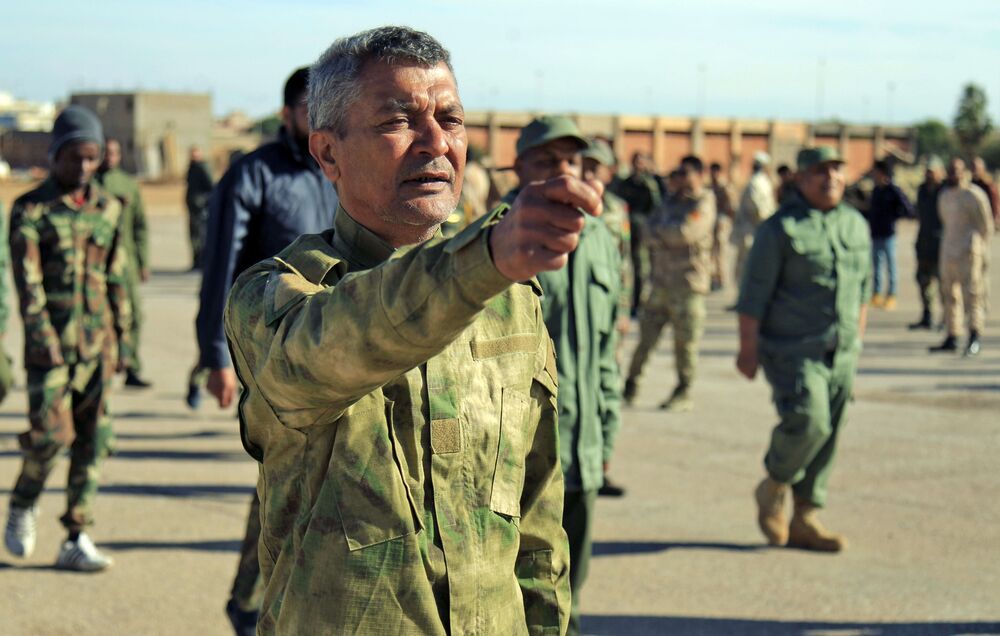 Fighters of a military battalion loyal to Libyan General Khalifa Haftar march during the morning assembly in Benghazi, Dec. 18. 