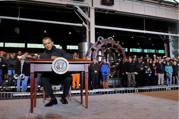 President Obama signs a memorandum after speaking at the U.S. Steel Irvin Plant in West Mifflin, Pa., on Jan. 29
