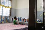 The youngest son of Hani Bin Sha'ari looks at photos of his father at the family home in Sungai Rambai, Malaysia, on Oct. 25.