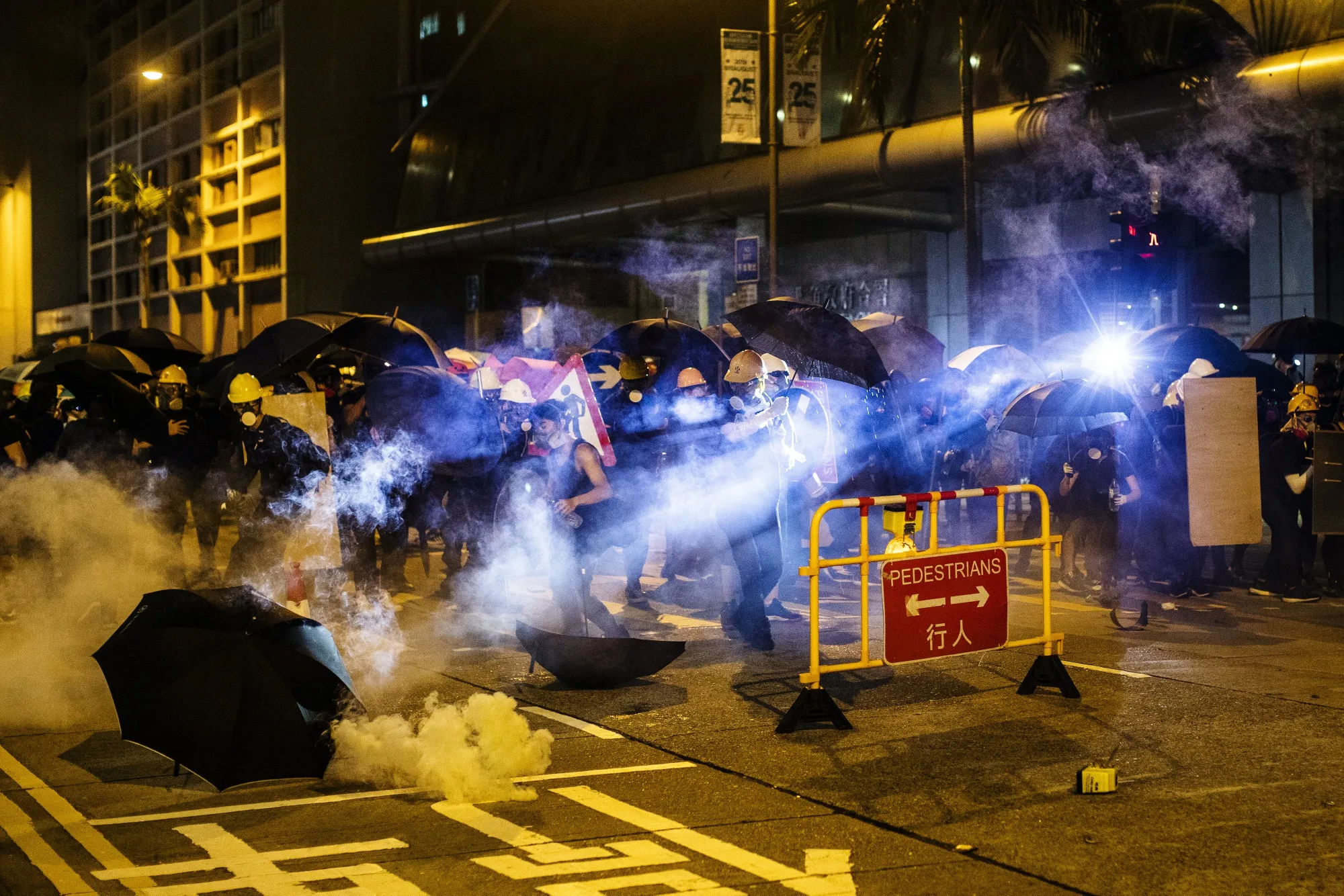 Demonstrators are shrouded in a cloud of tear gas outside the North Point Police Station on Aug. 5.