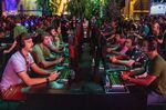 Attendees play a UbiSoft Entertainment SA game during the E3 Electronic Entertainment Expo in Los Angeles.