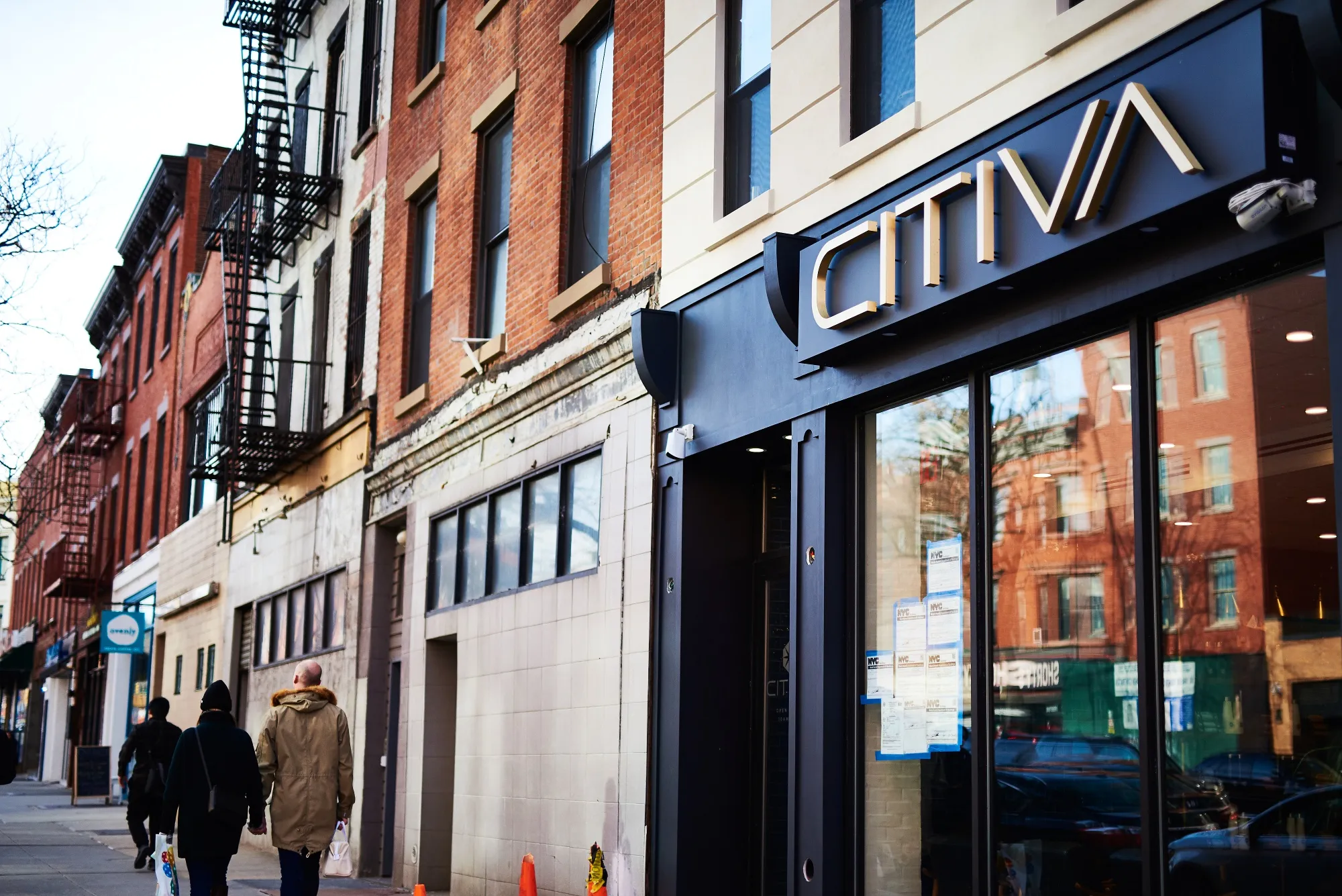 Pedestrians pass in front of a marijuana dispensary in New York.