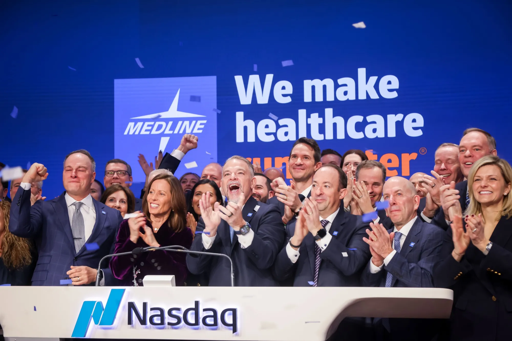 Jim Boyle, chief executive officer of Medline Inc., center, rings the Nasdaq opening bell.
