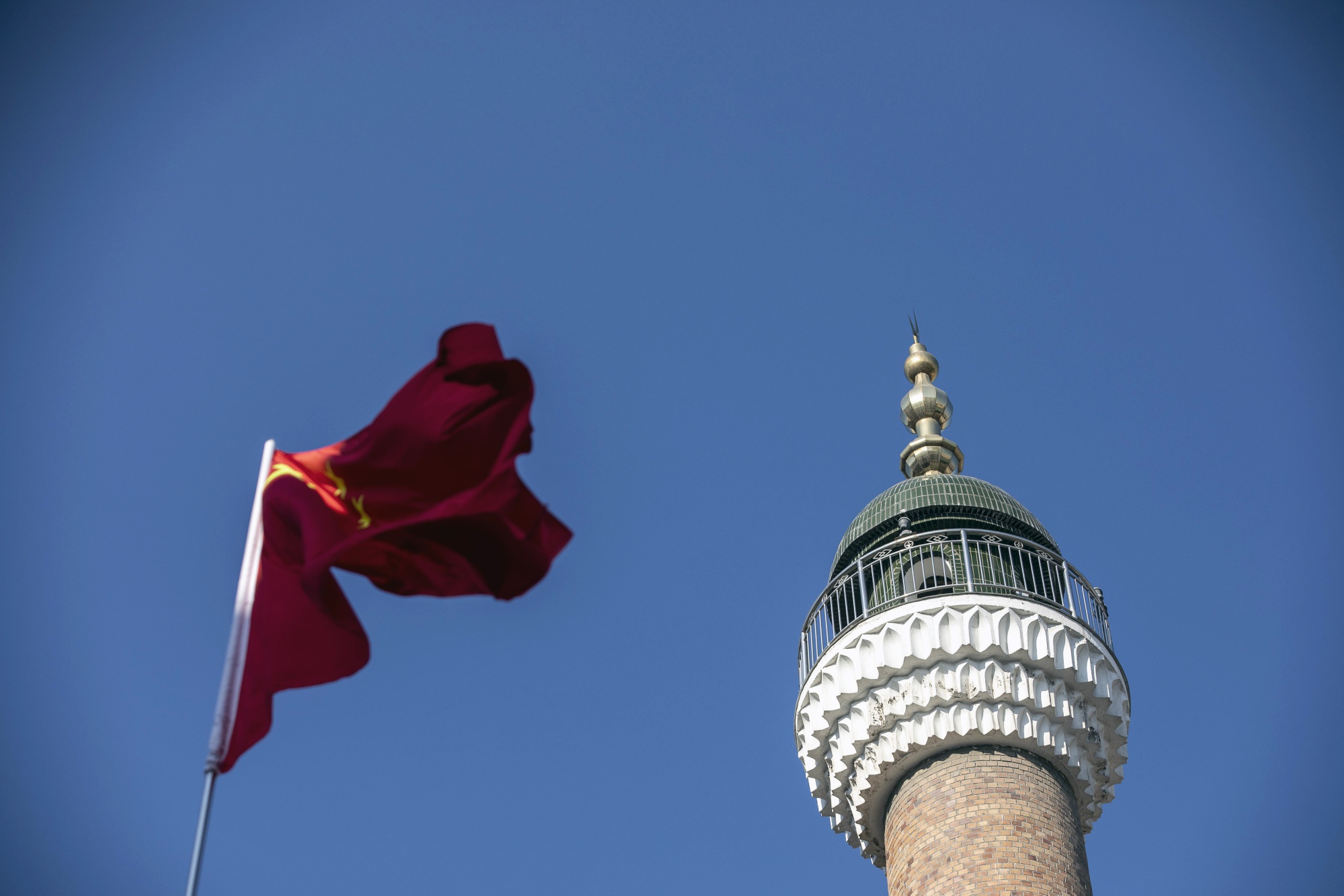 A Chinese flag flies in front of a mosque in Urumqi, capital of the northwestern province of Xinjiang.