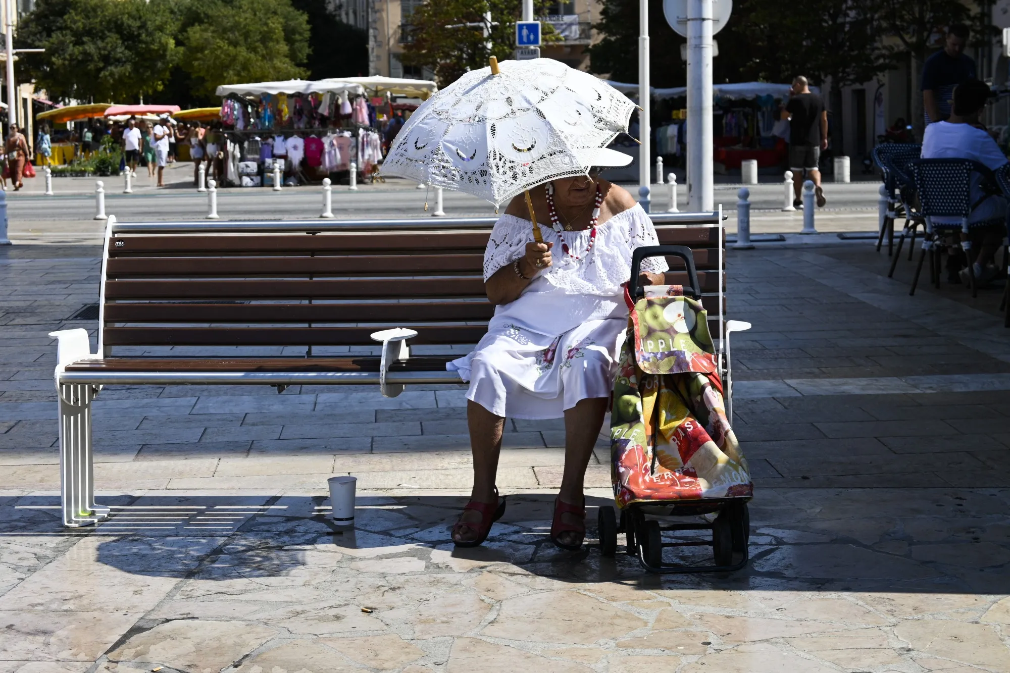 A person protects herself from the sun with a hat and an umbrella against the heat&nbsp;in Toulon, France&nbsp;on July 27.