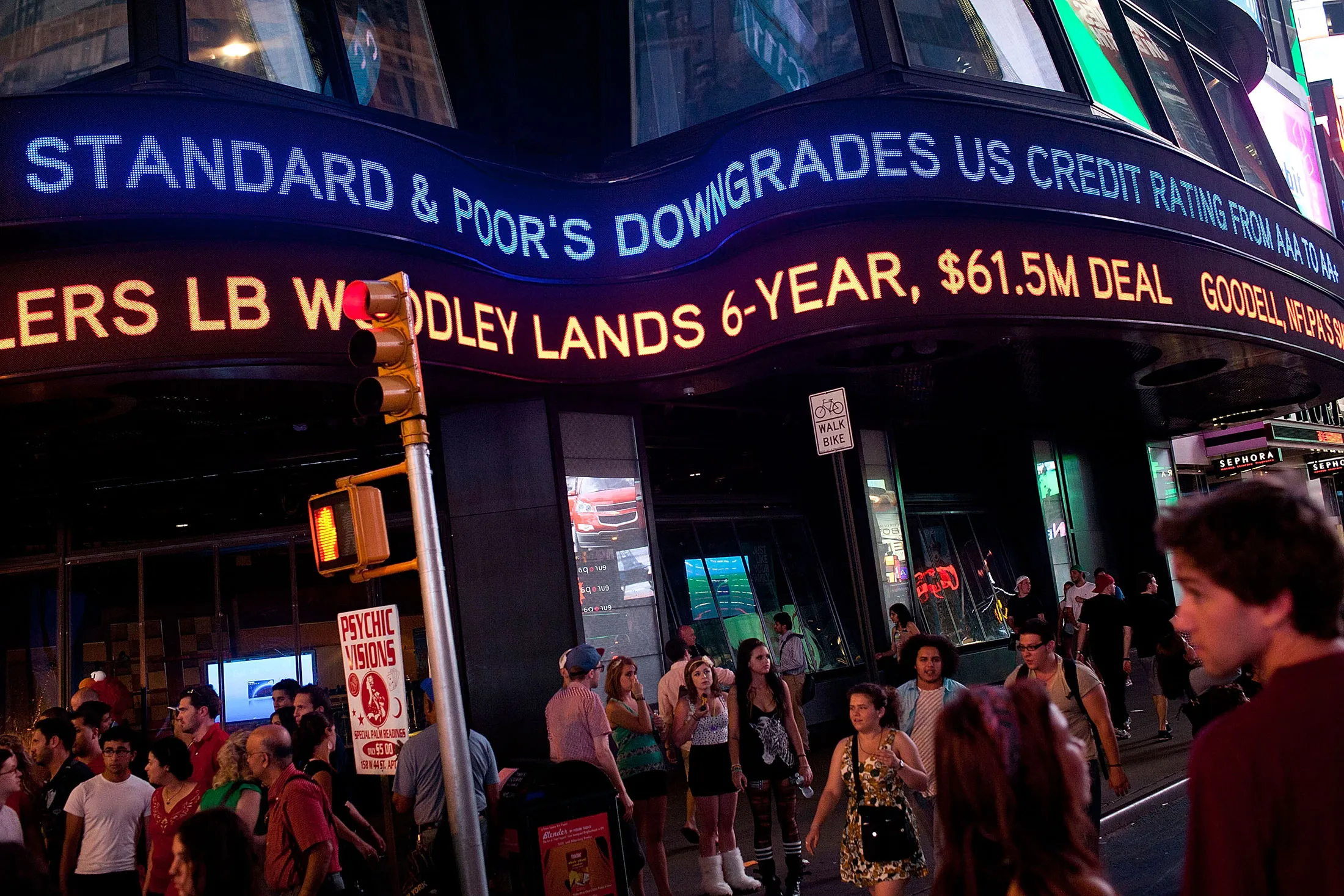 An ABC News ticker in Times Square announces a U.S. credit downgrade on Aug. 5, 2011.
