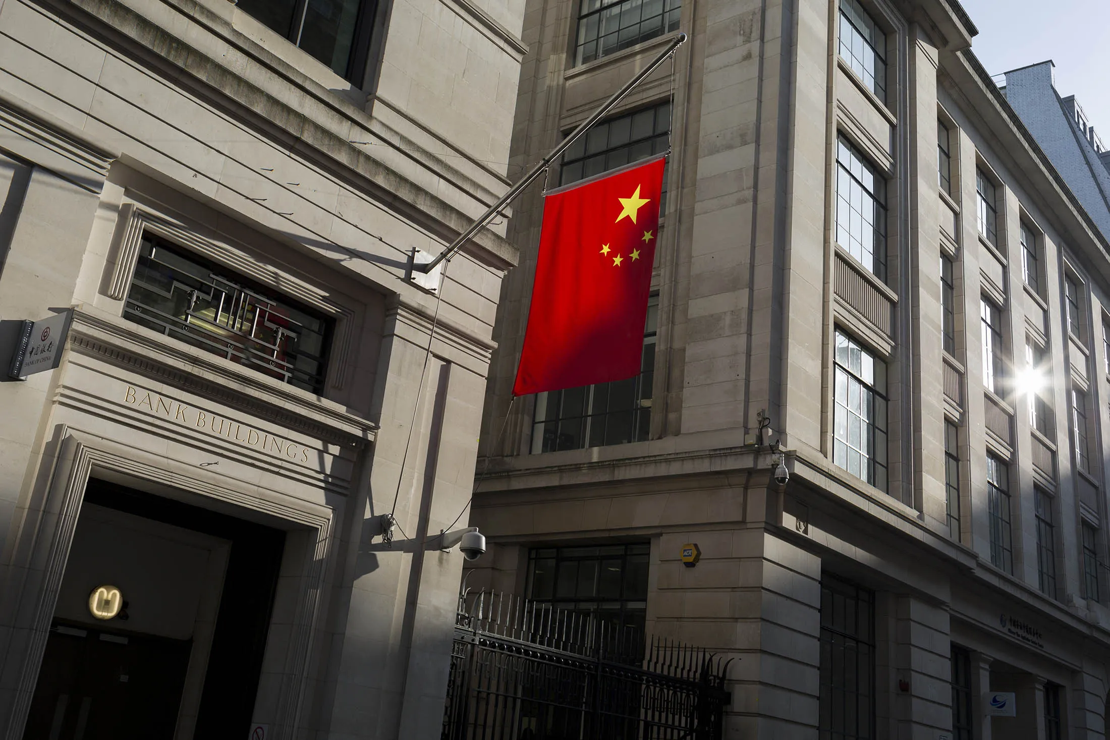The Chinese national flag hanging in sunshine from the Bank of China's headquarters, on 13th February 2017, in the City of London, United Kingdom. The Bank of China (BOC) BOC opened its first overseas branch in London in 1929.
