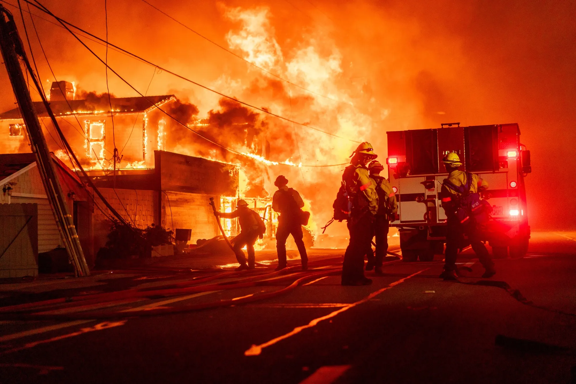 Firefighters battle flames during the Palisades Fire in the Pacific Palisades neighborhood of Los Angeles in January 2025.&nbsp;