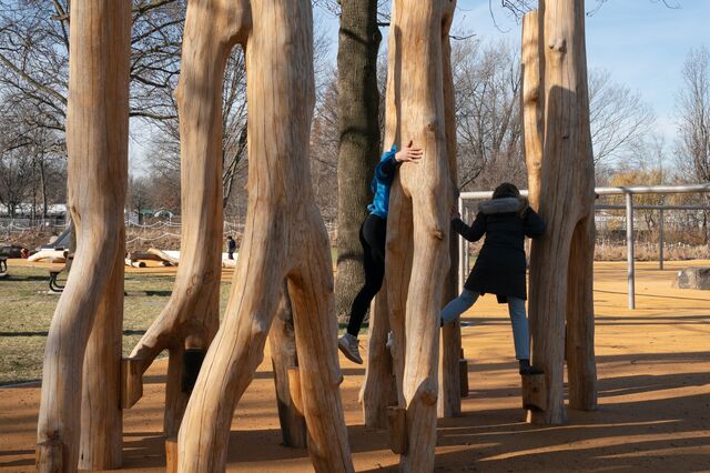Visitors play on a log climber at the Anna C. Verna Playground. 