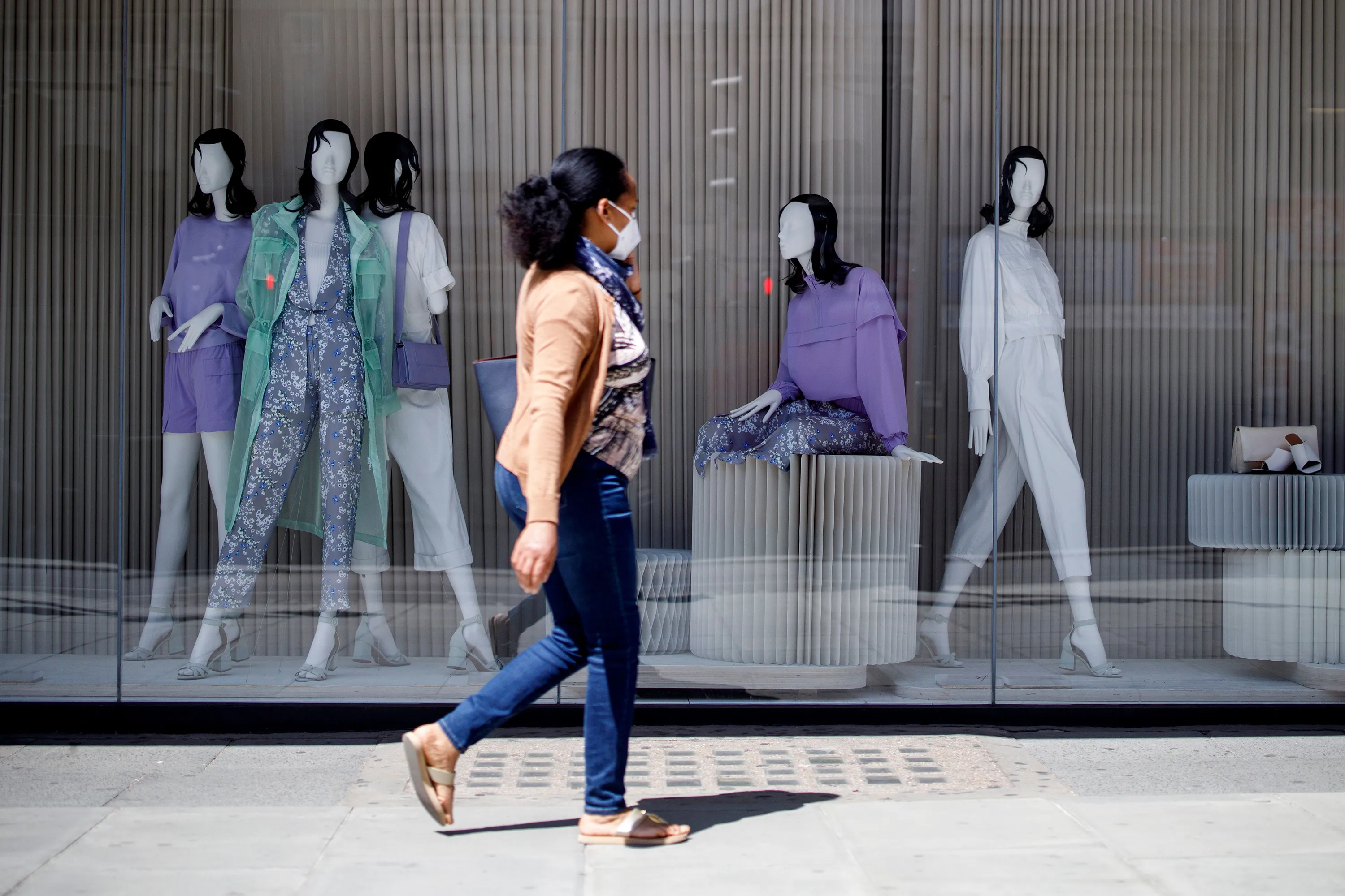 A woman walks past a closed shop in London on May 29.&nbsp;