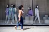 A woman walks past a closed shop in London on May 29. 