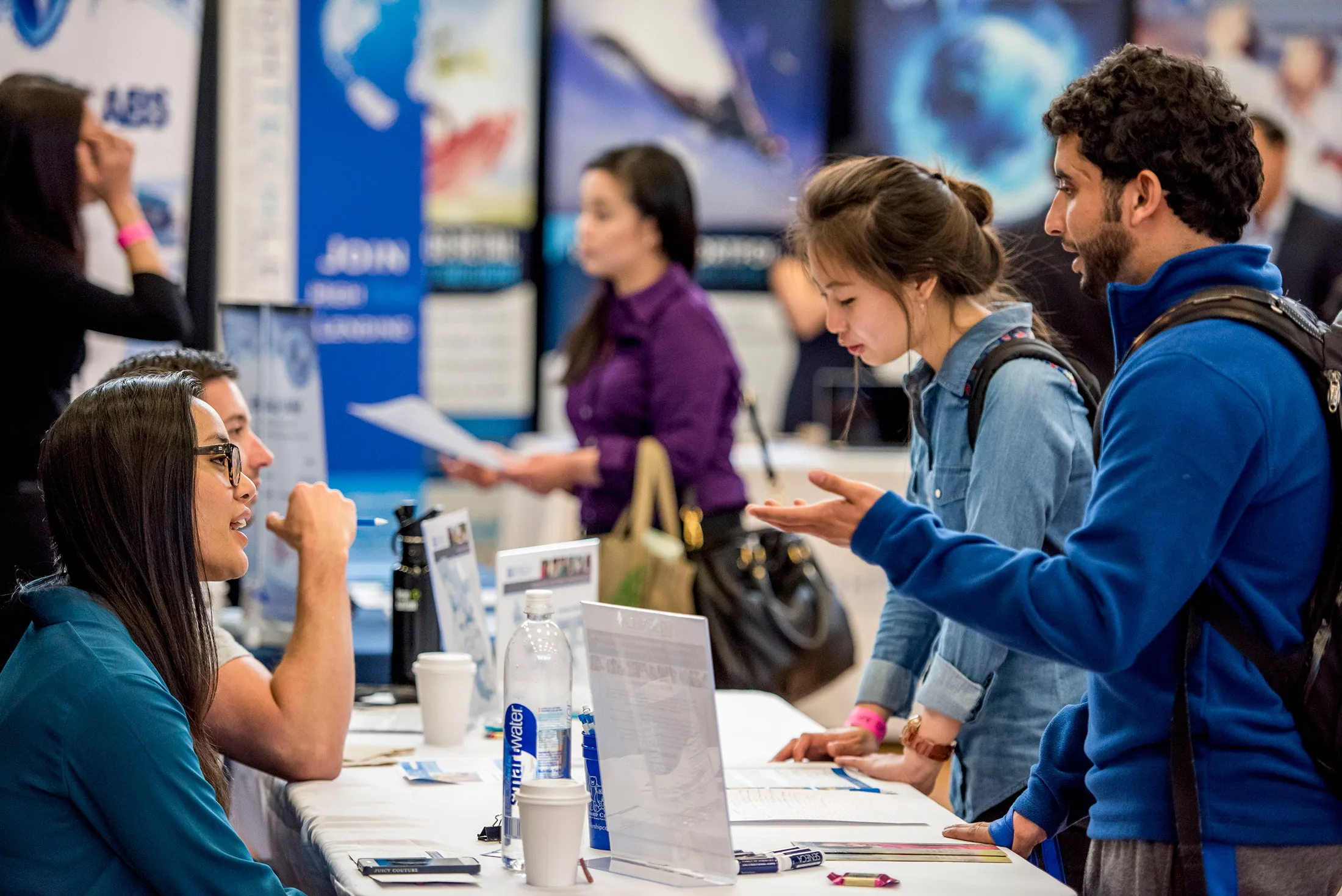 A job seeker, right, speaks with a recruiter during a career fair at San Francisco State University in San Francisco on April 3.
