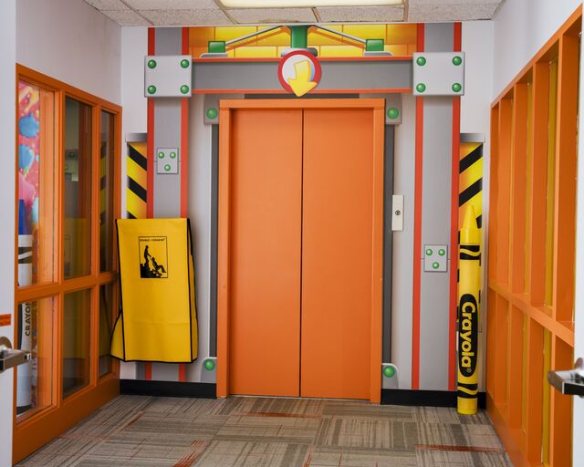 The elevator at the corporate entrance is painted Vivid Tangerine.