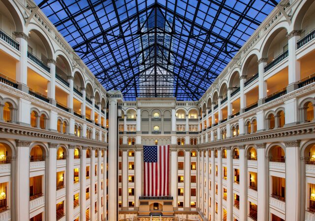The grand lobby atrium at the Waldorf Astoria DC, flanked with soaring columns.