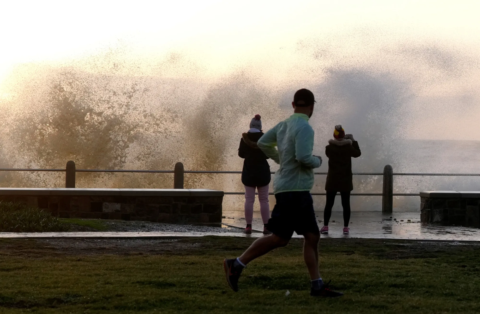 Waves break over Sea Point's promenade in Cape Town, on July 8.