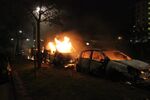 Cars burn during riots in Stockholm in 2013.