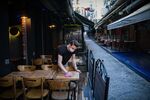 An employee cleans the terrace tables at a cafe in Istanbul.