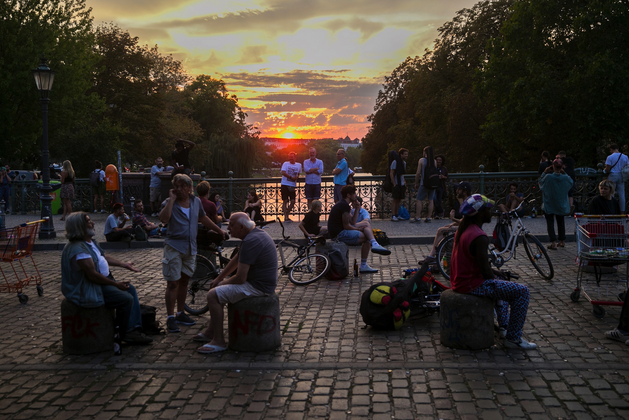 Berliners relax on a bridge at dusk in the Kreuzberg district in Berlin on Sept. 16.