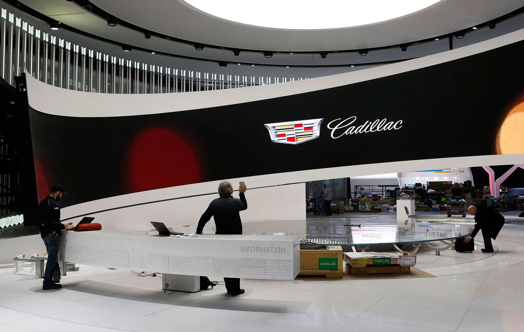 Workers prepares the General Motors Co. Cadillac exhibit ahead of the North American International Auto Show at the Cobo Center in Detroit, Michigan, U.S., on Friday, Jan. 8, 2016. The press preview officially begins on Monday, January 11. Last year's show featured 55 vehicle introductions and was attended by over 5,000 journalists from 60 countries.
