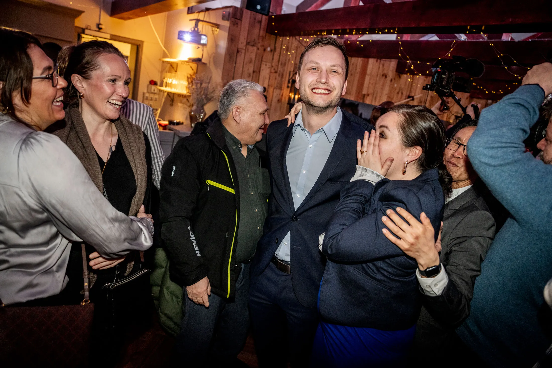 Demokraatit party leader Jens-Frederik Nielsen, center, celebrates in Nuuk on March 11.