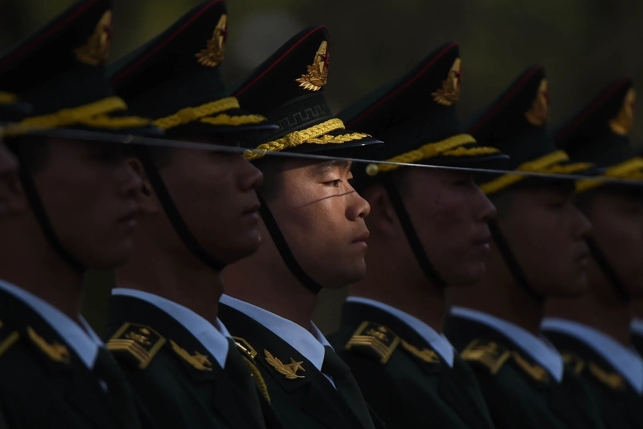 TOPSHOT - Members of a Chinese military honour guard prepare before a welcome ceremony for Swiss President Johann Schneider-Ammann in Beijing on April 8, 2016. Schneider-Ammann was welcomed by Chinese President Xi Jinping for a state visit to China. / AFP / GREG BAKER (Photo credit should read GREG BAKER/AFP/Getty Images)

