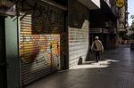 A pedestrian passes closed stores in the financial district of Buenos Aires, Argentina, on&nbsp;April 30.&nbsp;