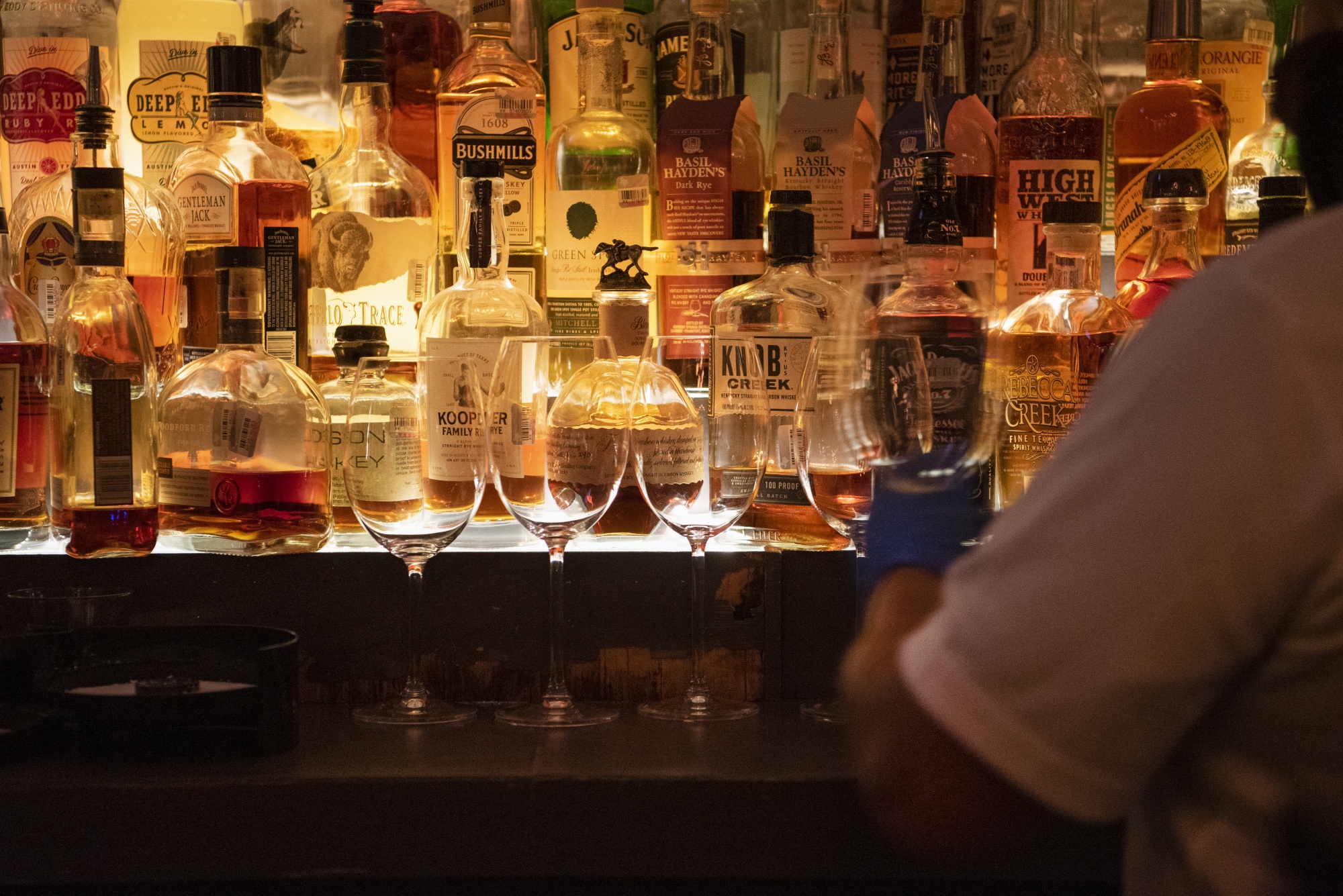Before the coronavirus, the U.S. alcohol industry struggled to&nbsp;respond to a shift toward healthier and lower-calorie options. The pandemic has only accelerated that shift. Above, a bartender wearing gloves cleans glasses at a restaurant in Houston on May 27, 2020.&nbsp;