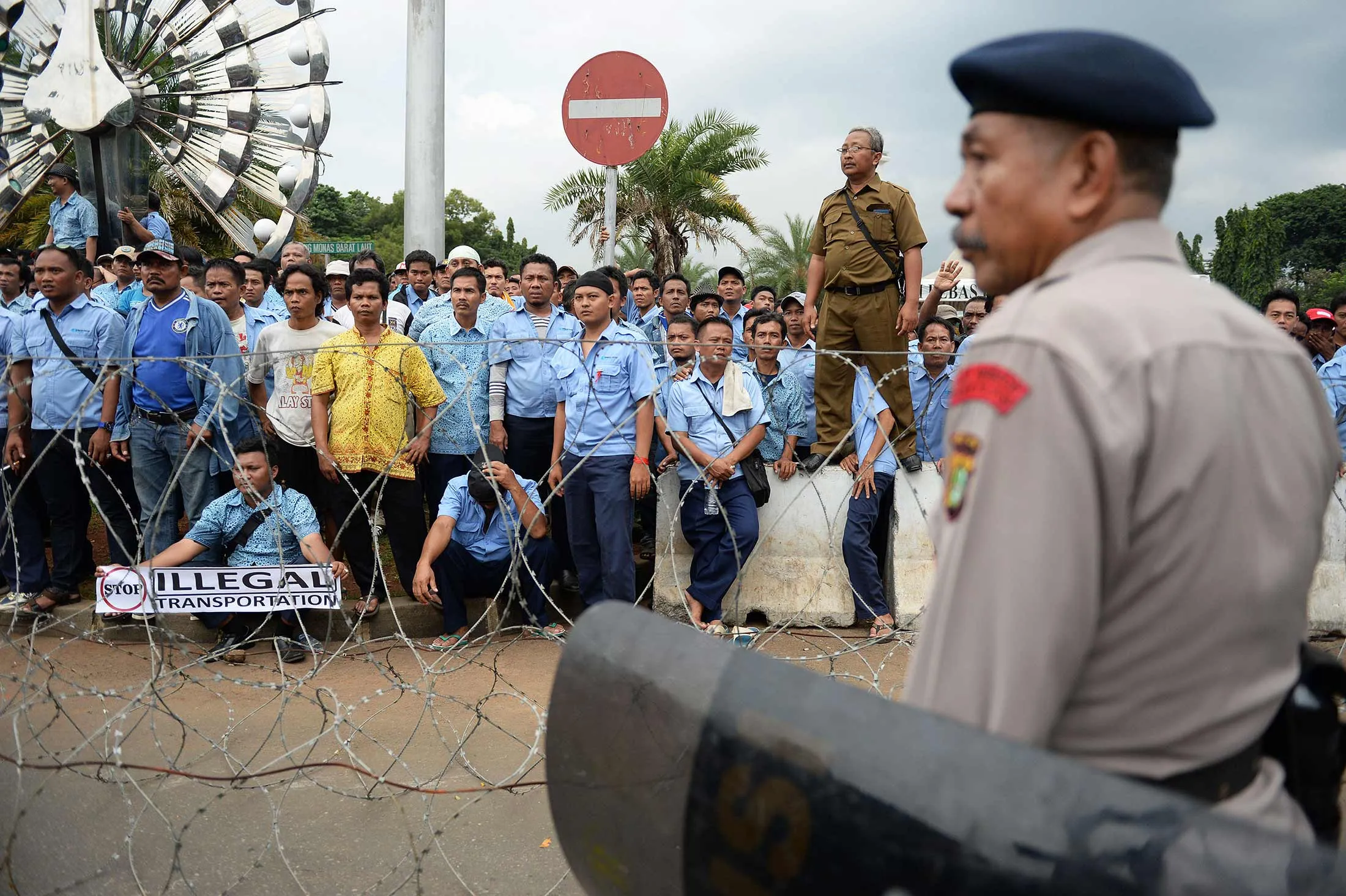 A police officer stands guard as taxi drivers take part in a protest in Jakarta, Indonesia, on March 22.
