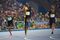 Jamaica's Usain Bolt (C) crosses the finish line to win the Men's 100m Final during the athletics event at the Rio 2016 Olympic Games at the Olympic Stadium in Rio de Janeiro on August 14, 2016. / AFP / OLIVIER MORIN (Photo credit should read OLIVIER MORIN/AFP/Getty Images)