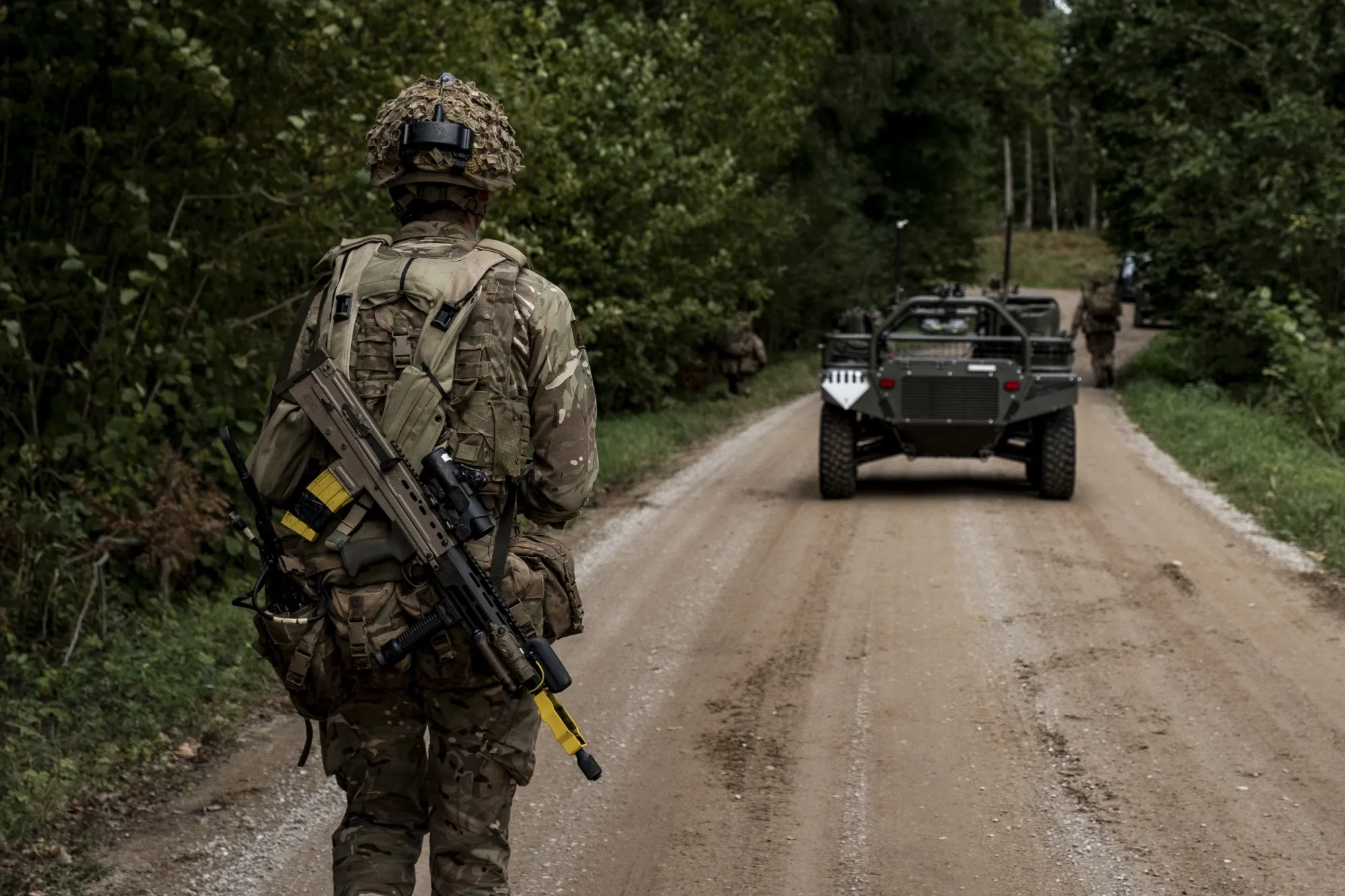 A soldier in front of a Viking, an Iveco Defence Vehicles unmanned ground vehicle (AGV), during NATO-linked military exercises&nbsp;in Latvia in&nbsp;2025.