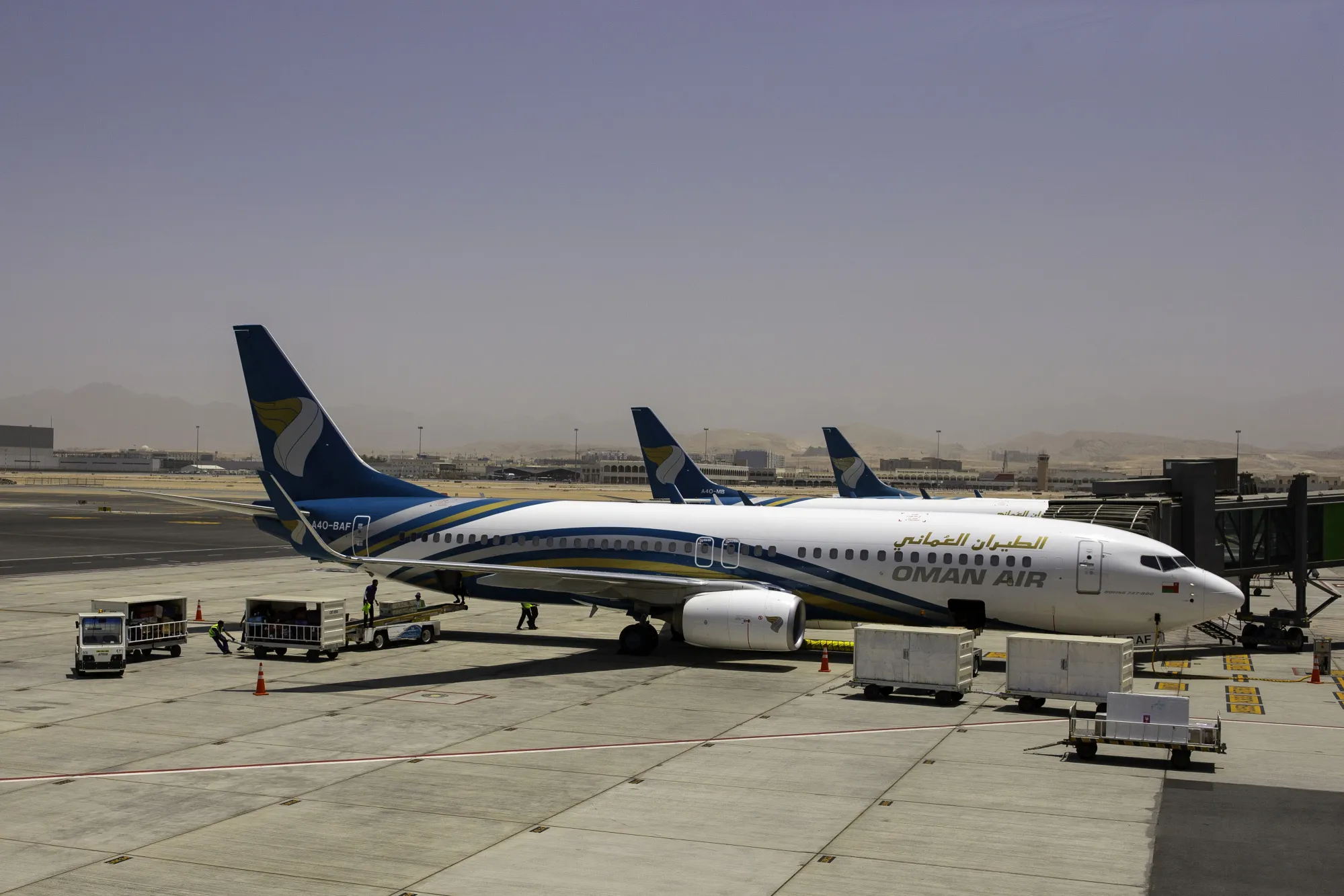 A Boeing Co. 737-800 aircraft, operated by Oman Air, stands beside the passenger terminal at Muscat International Airport in this file photo.