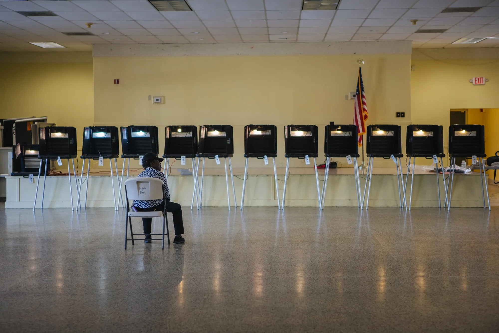 An election official sits in a chair while waiting for voters to arrive at a polling station in Miami, on March 17.