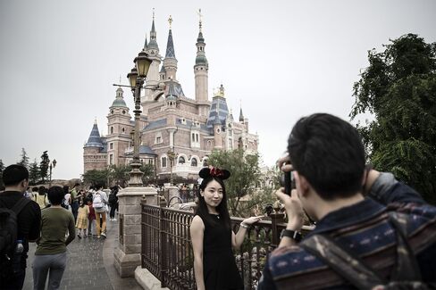 A visitor poses by the Enchanted Storybook Castle.