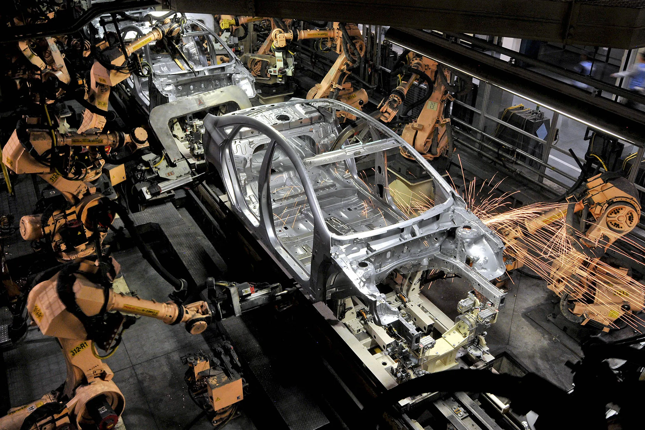Robotic arms work on an assembly line at the Hyundai Motor Manufacturing plant in Montgomery, Alabama.
