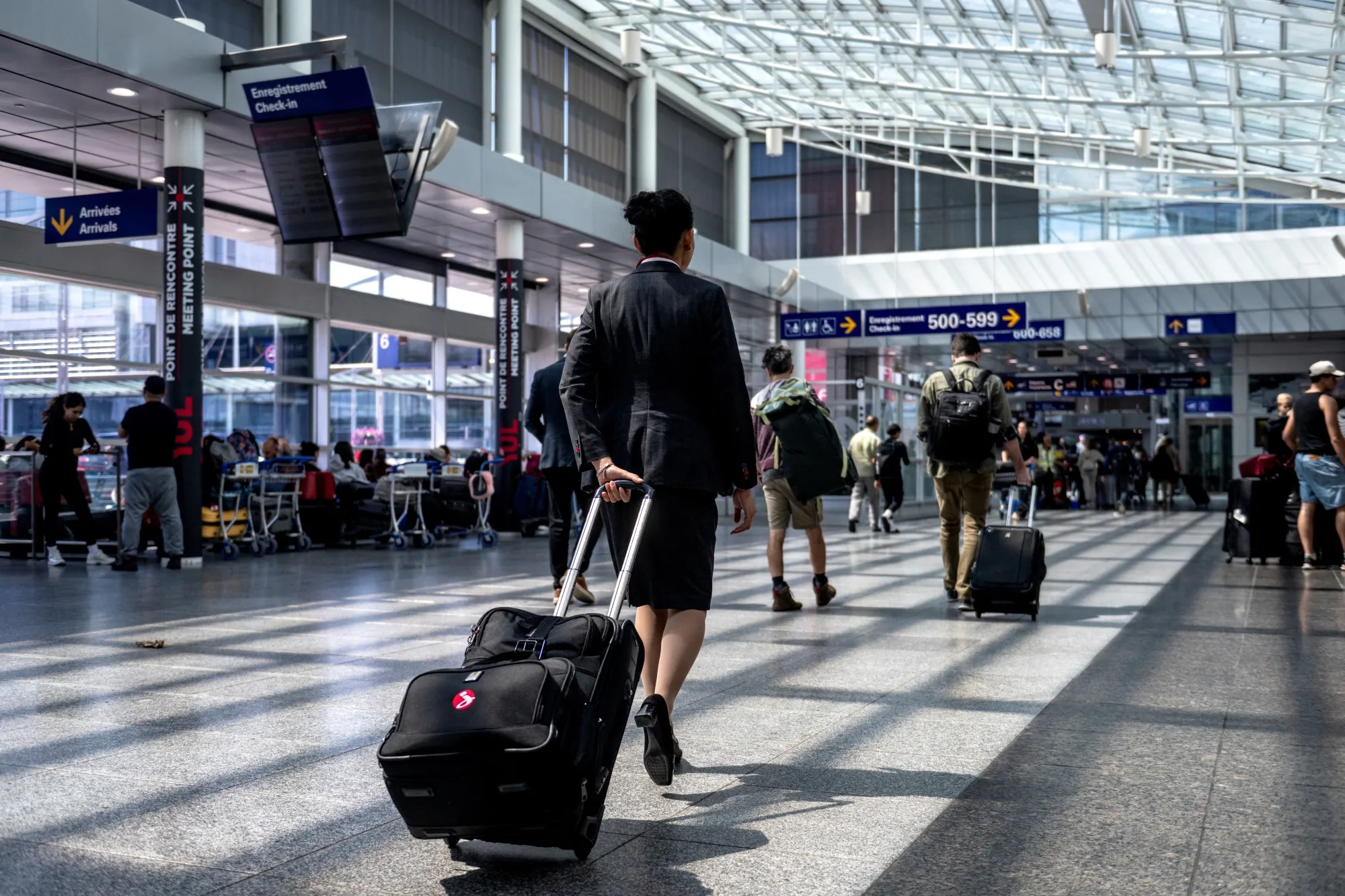 A flight attendant walks through the terminal at Pierre-Elliott Trudeau Airport in Montreal.