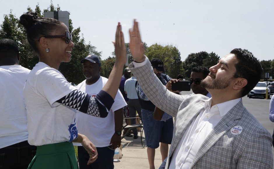 Michigan gubernatorial candidate Abdul El-Sayed high-fives a supporter in Detroit.