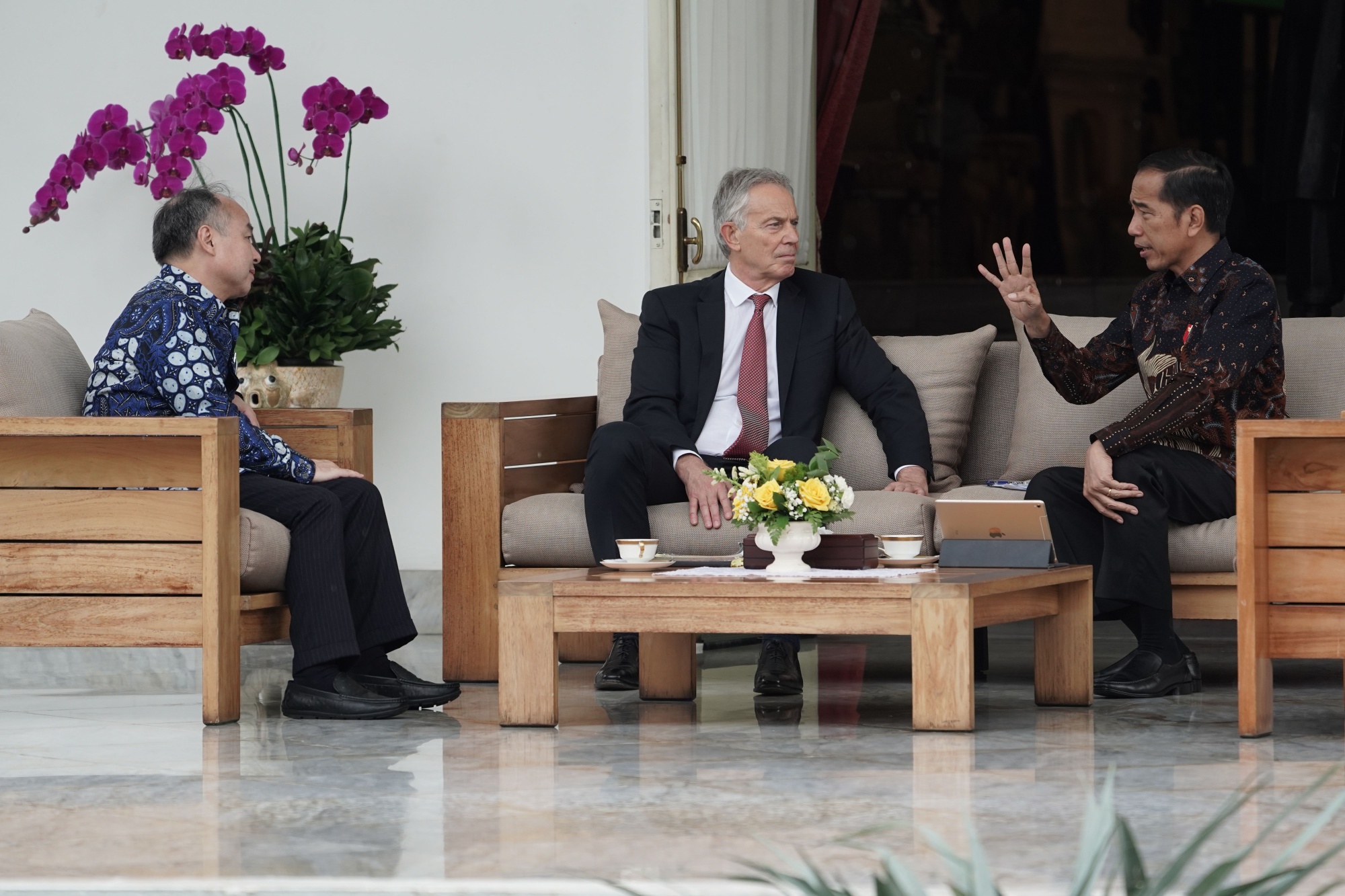 Joko, right, speaks with Tony Blair, center, and Masayoshi Son in Jakarta, Feb. 28. Photographer Dimas Ardian/Bloomberg