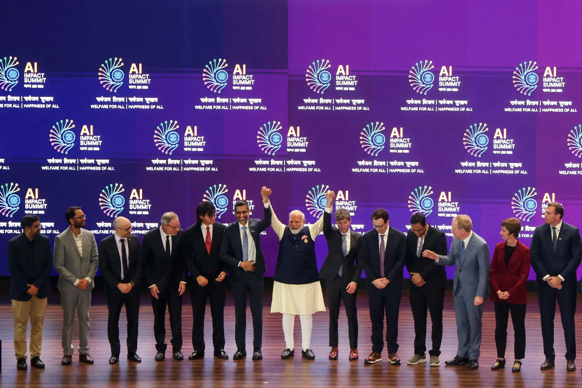 India’s Prime Minister Narendra Modi takes a group photo with company leaders at the AI Impact Summit in New Delhi.