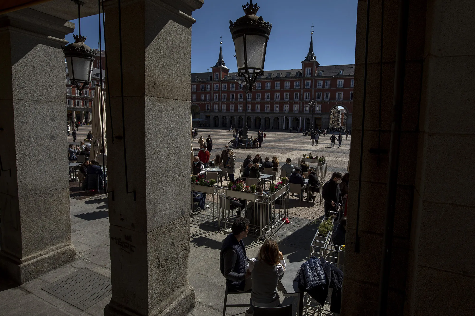 People sit at the terrace of a bar in Plaza Mayor Square&nbsp;in Madrid, on March 20.&nbsp;