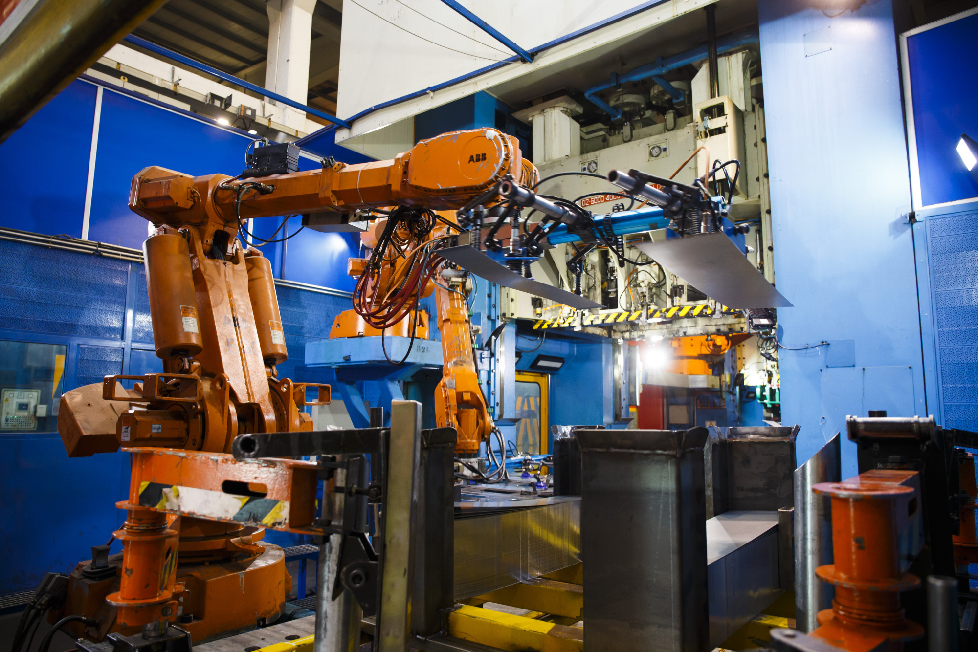 ABB Ltd. robotic arms position steel sheets for stamping auto parts in Spain.