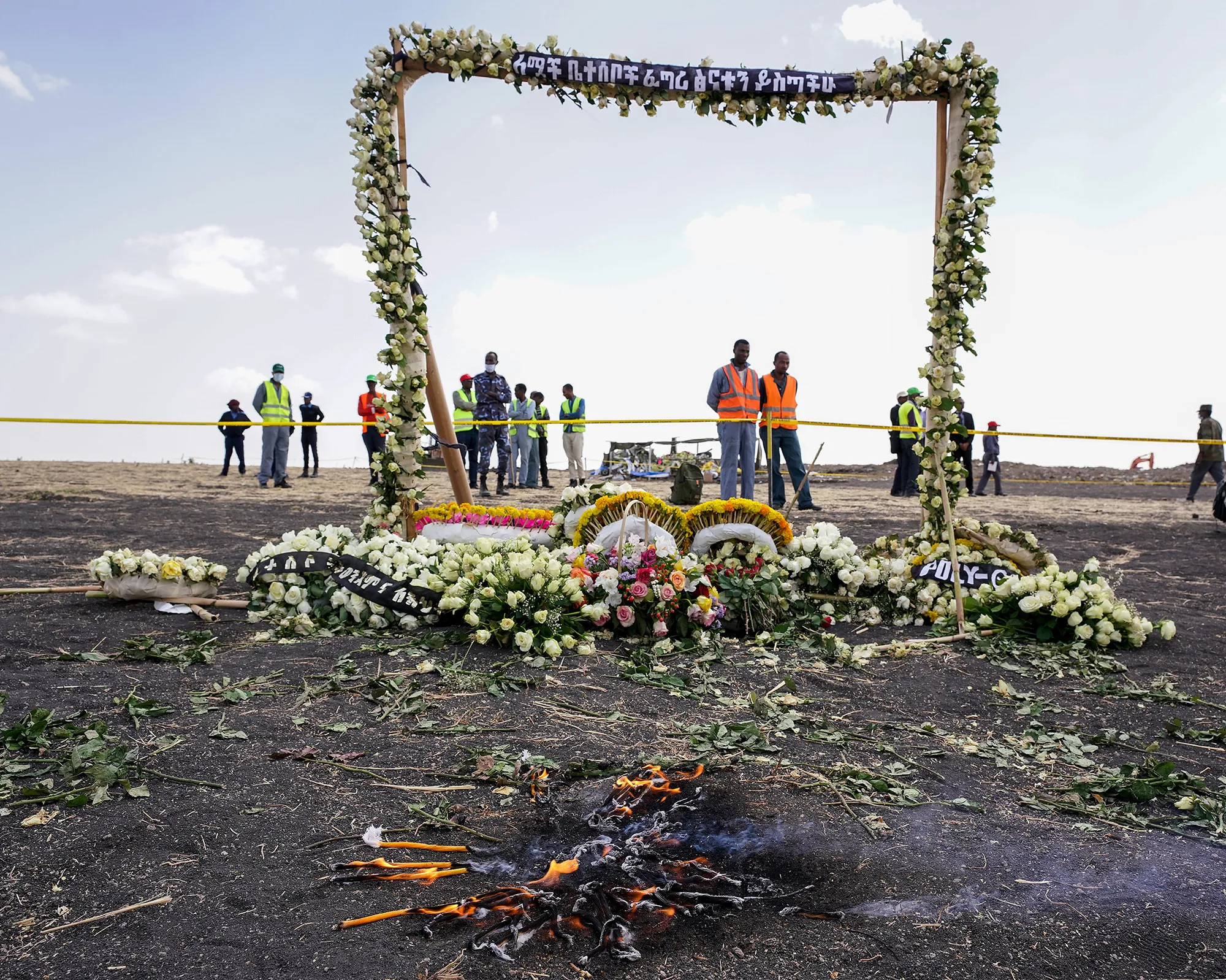 Candles burn before a flower adorned memorial arch erected at the site of the Ethiopian Airlines flight ET302 crash in Ejere, Ethiopia,&nbsp;on March 14, 2019.
