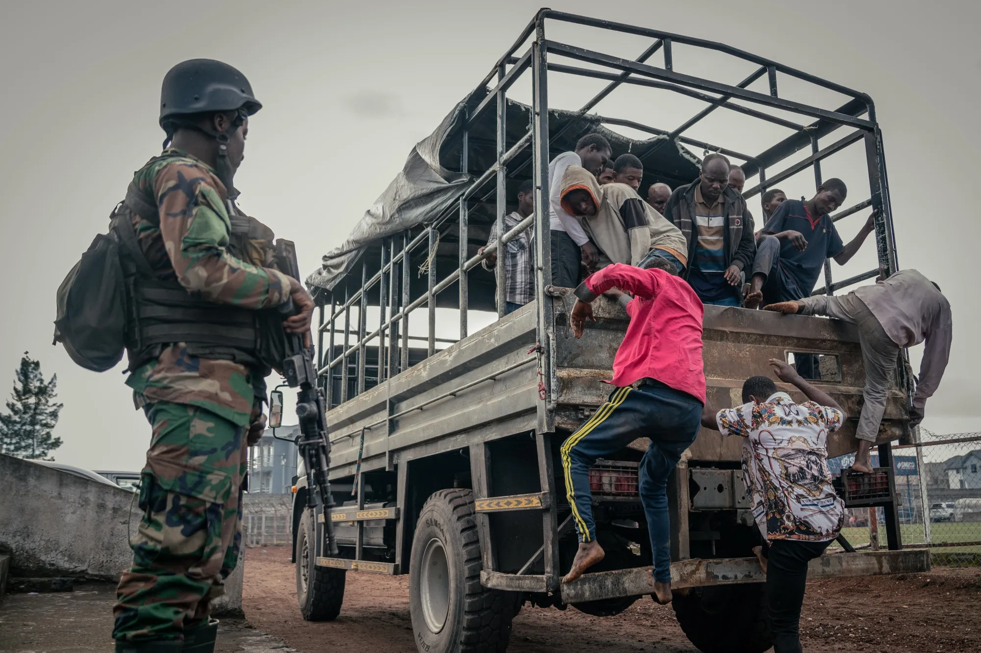 An M23 soldier watches over a group of Democratic Forces for the Liberation of Rwanda and Wazalendo and Armed Forces of the Democratic Republic of the Congo fighters in Goma, Democratic Republic of the Congo, on May 10.