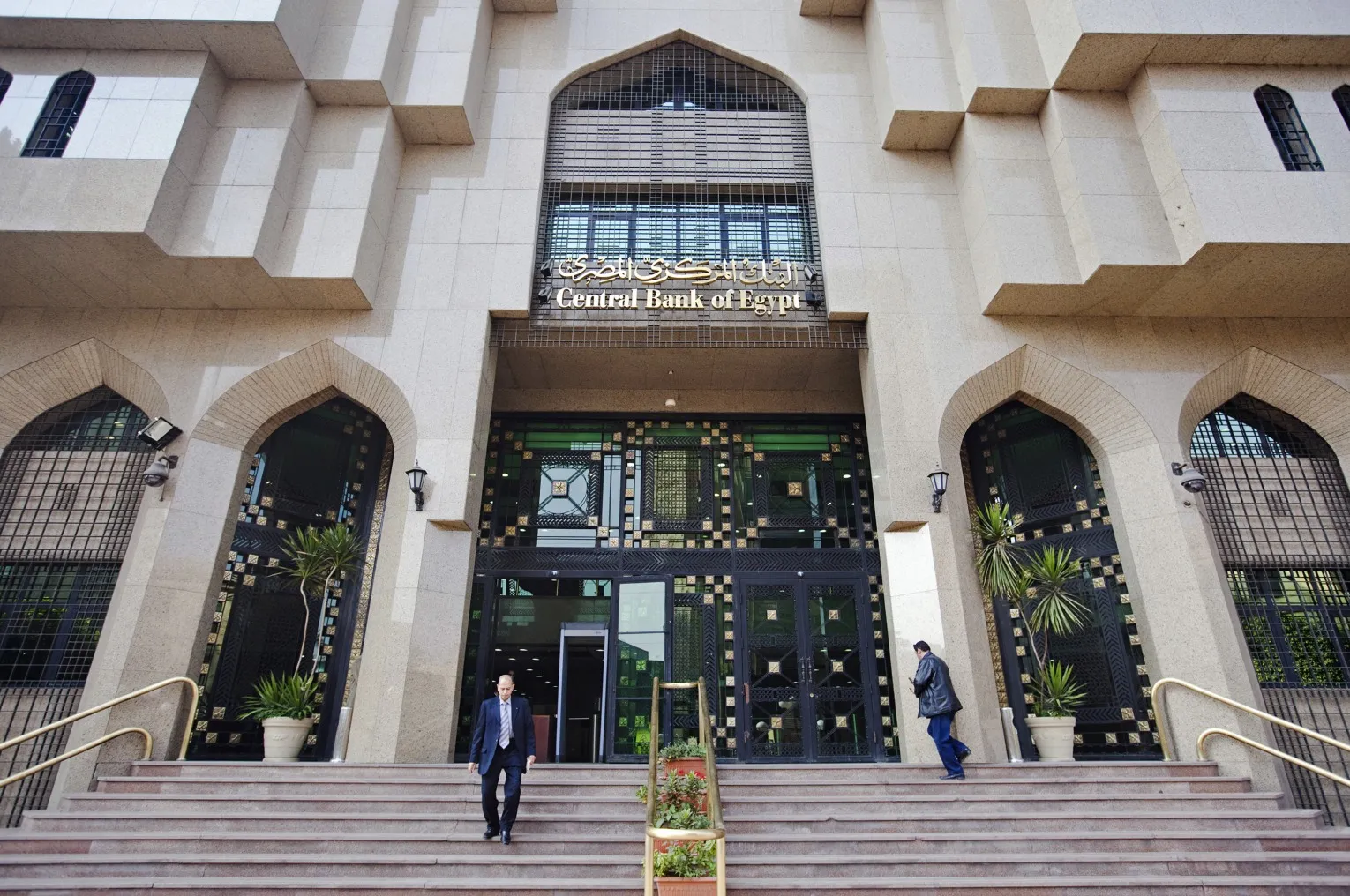Pedestrians use the stairs outside of Egypt's central bank in Cairo, Egypt.