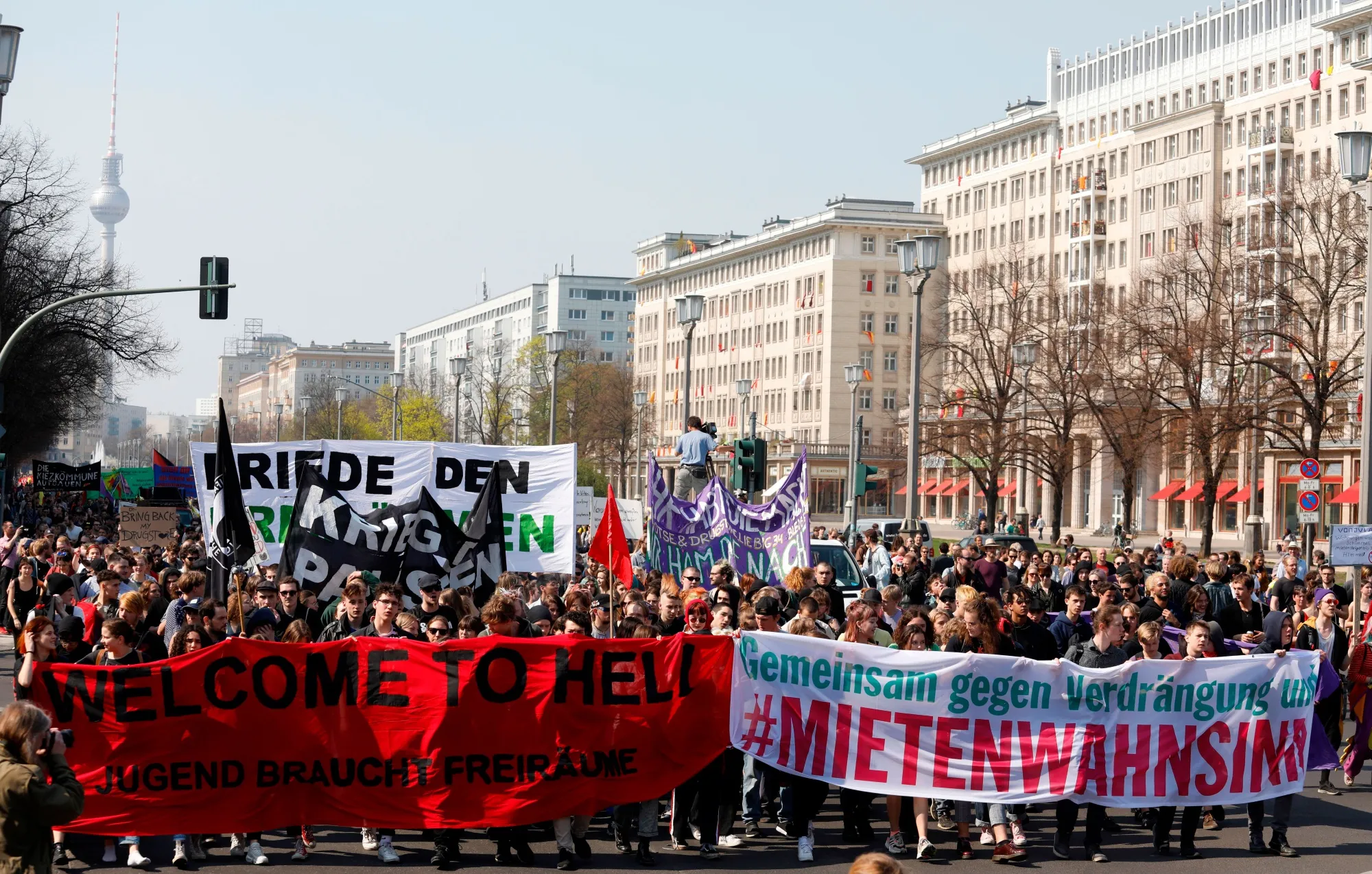 Protestors walk along Karl Marx Allee in Berlin on April 6.