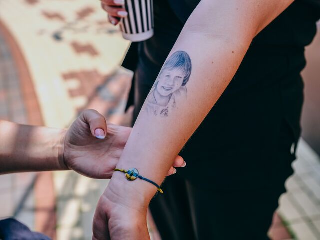 Olha Holynska shows a tattoo of Sofiya on her inner arm