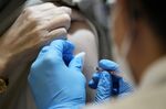 A healthcare worker administers a Moderna Covid-19 vaccine booster shot at a mass vaccination site in Tokyo.