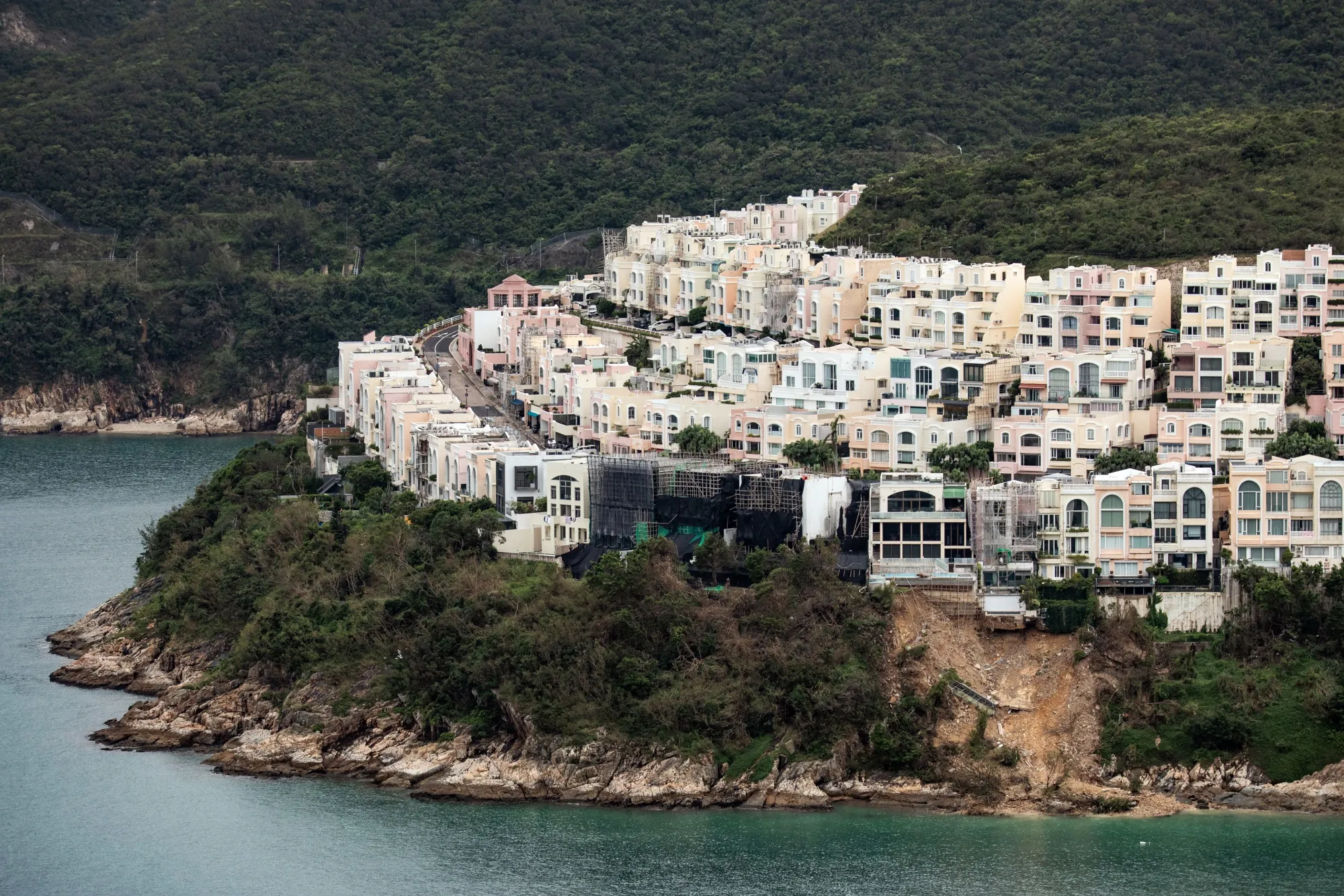 The landslide below the Redhill Peninsula estate which exposed unauthorized basements.