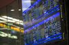 An electronic billboard displays stock information on the trading floor of the Hong Kong Stock Exchange in Hong Kong, China, on Friday, Dec. 20, 2013. China Everbright Bank Co. shares declined in their Hong Kong trading debut after the lender raised $3 billion in the city’s biggest first-time share sale this year to strengthen capital buffers.
