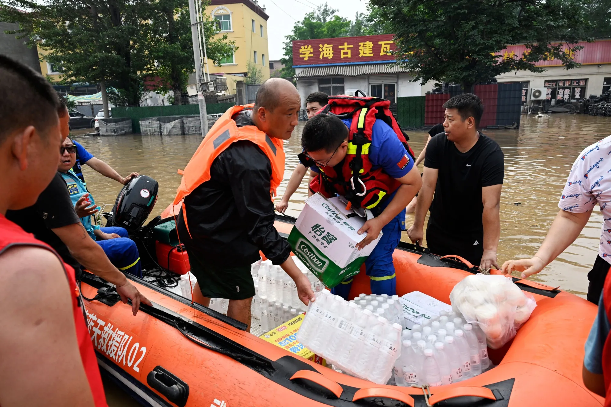 Rescue team members prepare supplies for the residents stuck in their homes following heavy rains in Hebei province on Aug. 2.