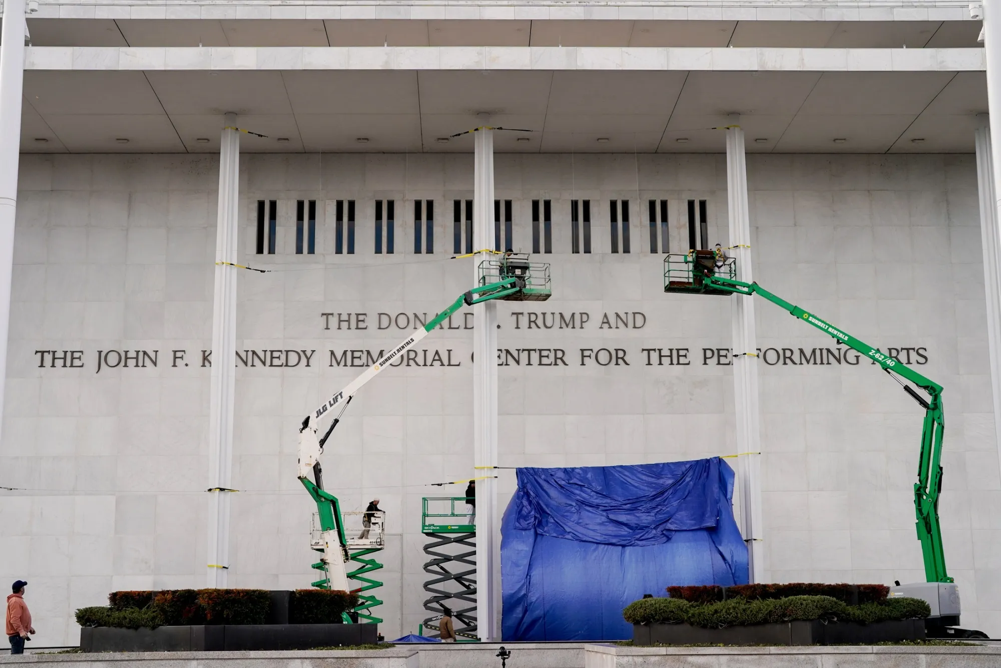 Workers add US President Donald Trump's name to the facade of the John F.&nbsp;Kennedy Center in Washington, DC, in December.